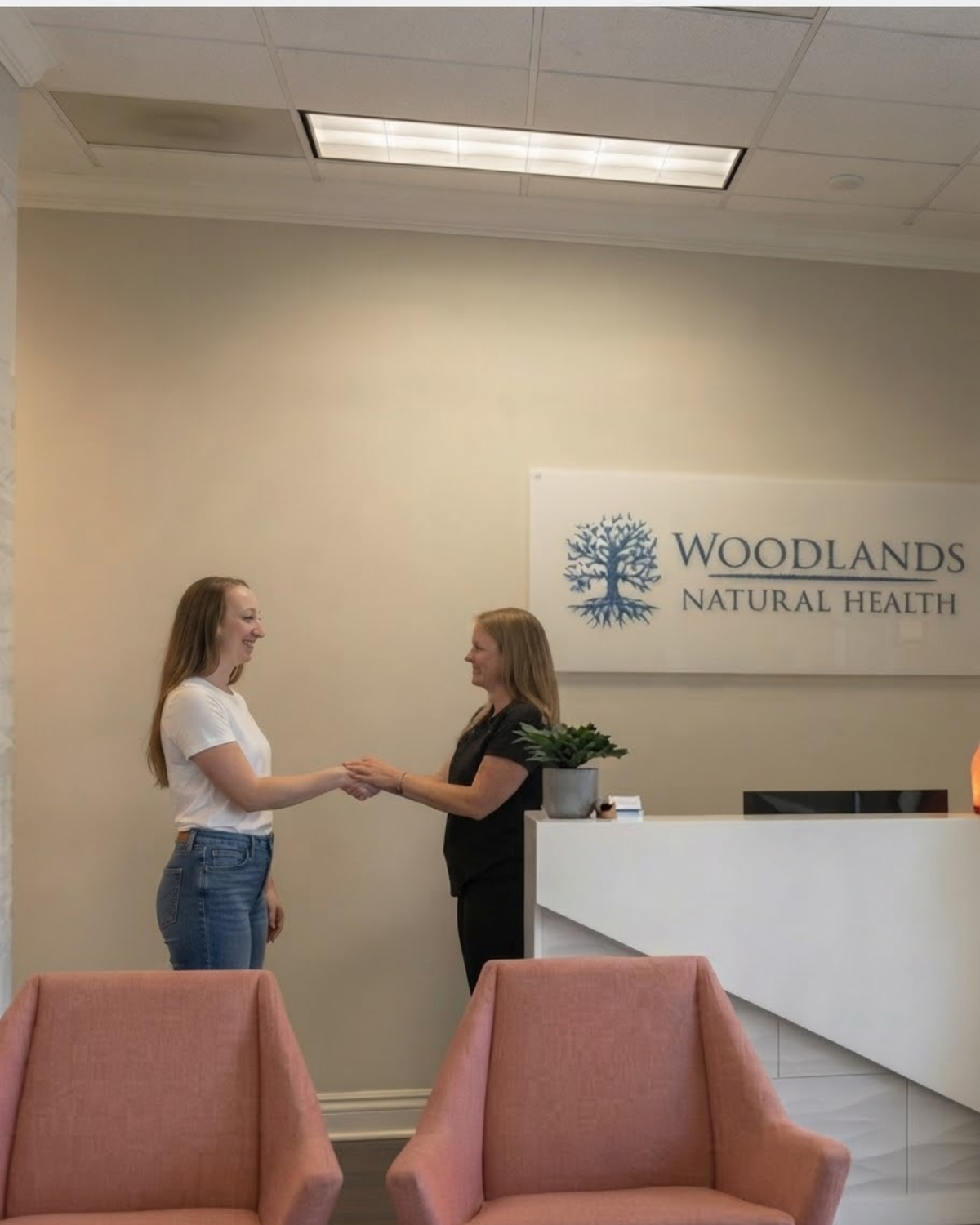 Wellness specialist welcoming a client at the Woodlands Natural Health reception in Tomball, TX